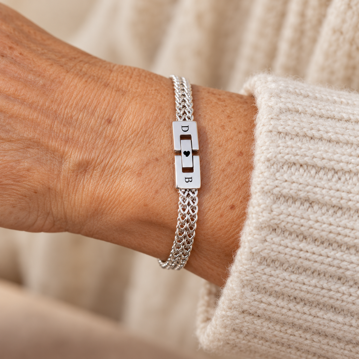 Silver D and B clasp bracelet on wrist