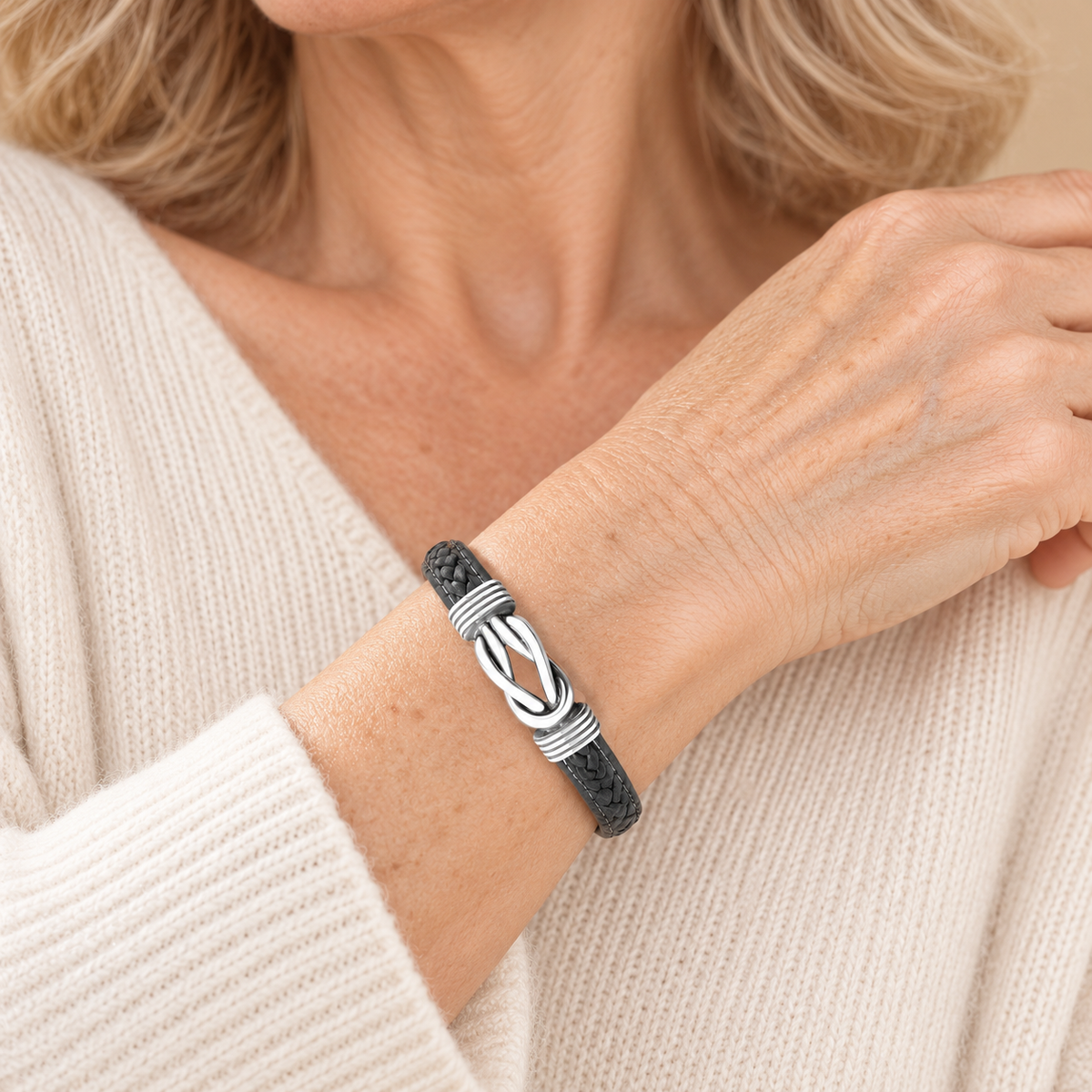 Charcoal leather infinity knot bracelet on mature model