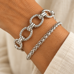 Silver paperclip and woven chain bracelet set on wrist