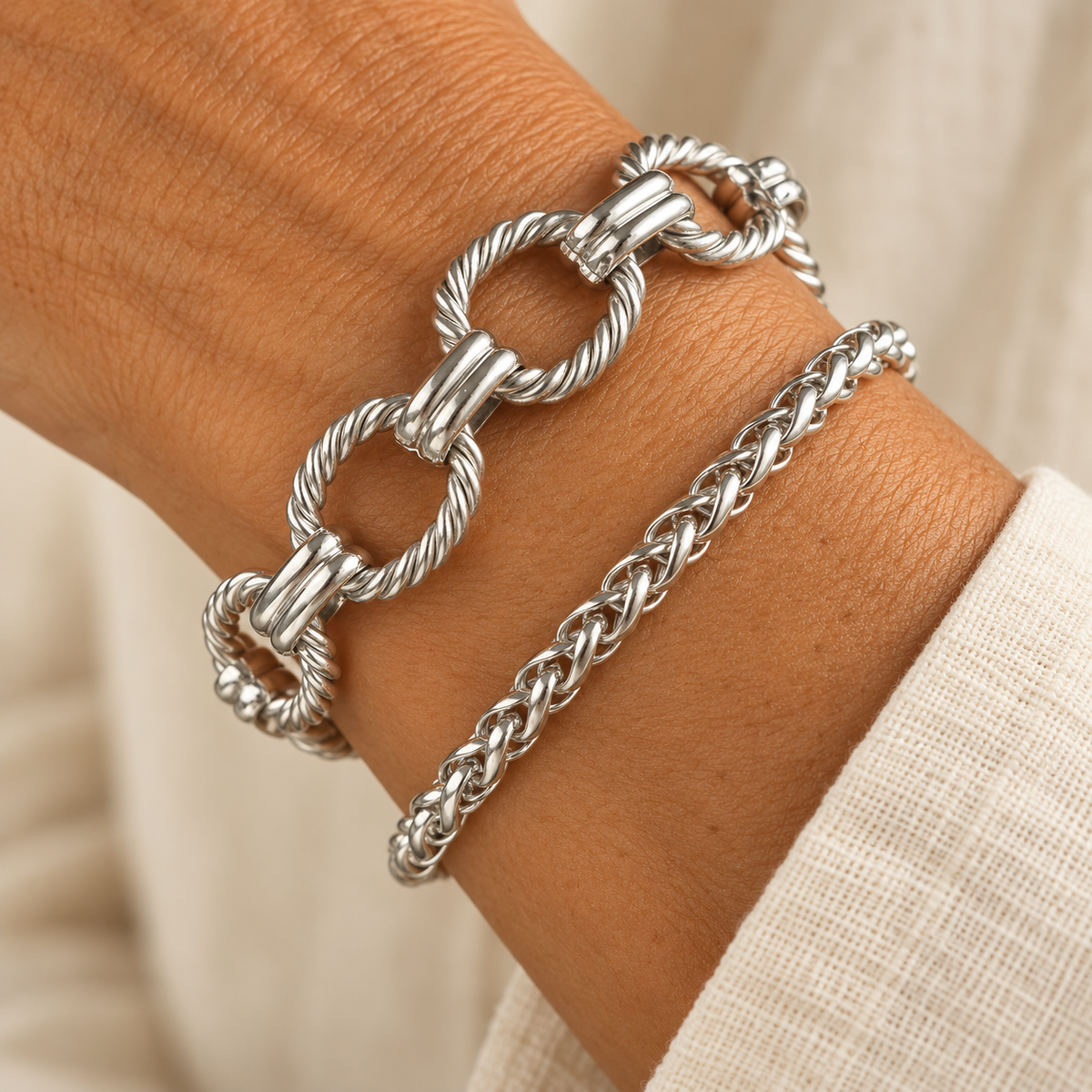 Silver paperclip and woven chain bracelet set on wrist