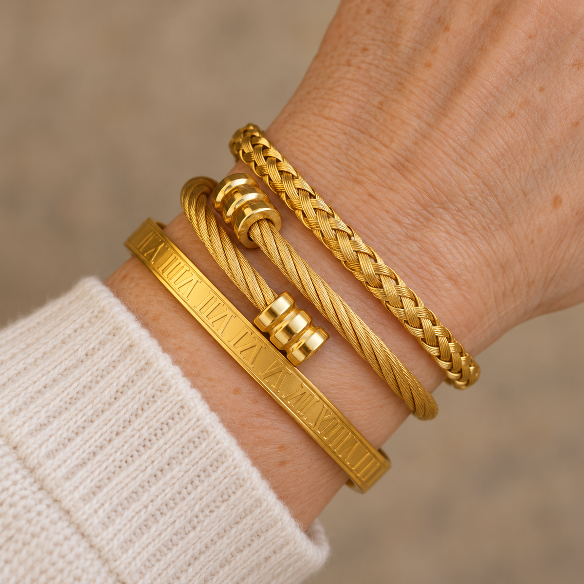 Three gold bracelet stack on mature wrist