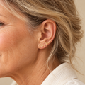 Gold personalised Sophie name earrings on mature model