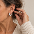 Chunky polished silver hoop earring on mature model