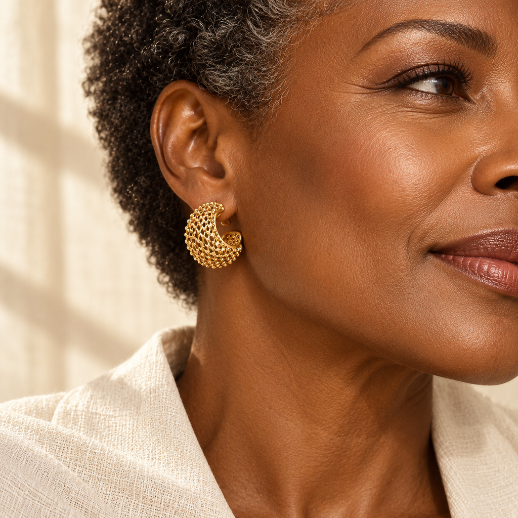 Evelise gold mesh C hoop earrings on a woman
