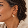 Evelise half diamond hoop earrings on a woman