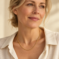 Gold rope necklace on mature woman