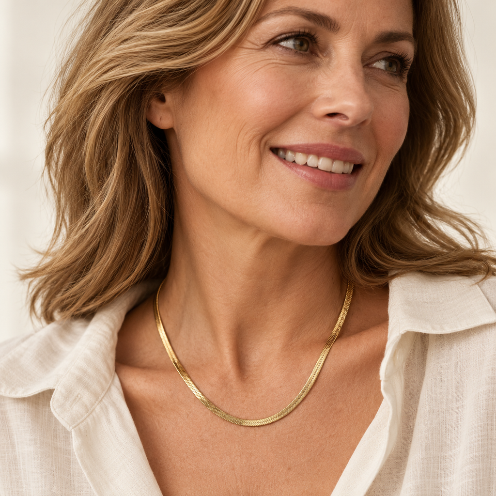 Gold herringbone necklace on mature woman