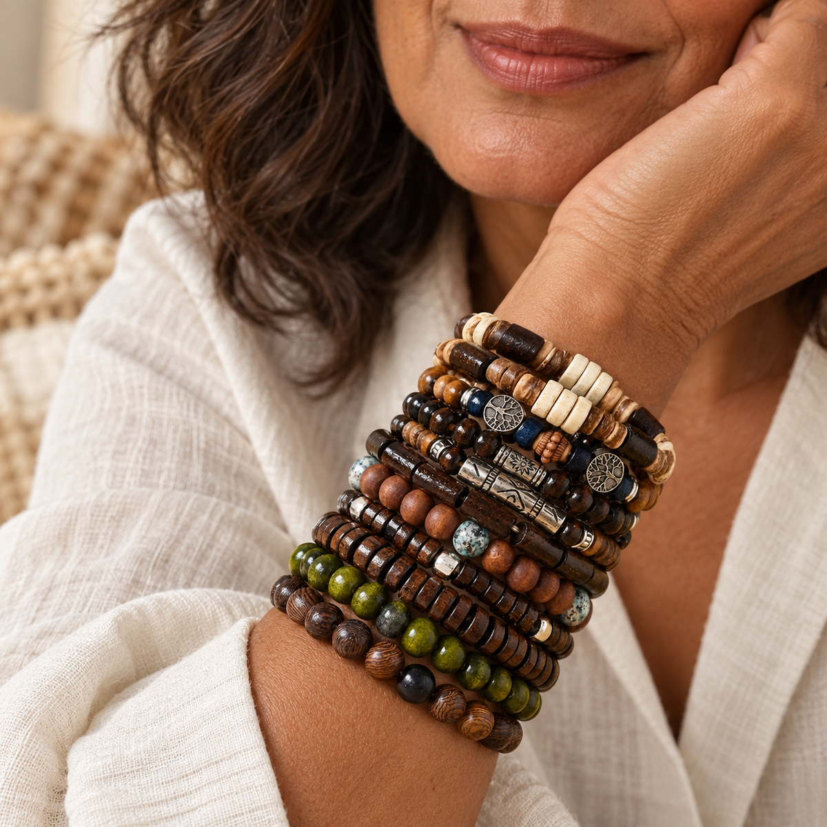 Ten boho bracelets stacked on a woman's wrist