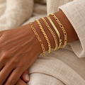 Five Evelise chain bracelets on a woman’s wrist