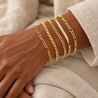 Five Evelise chain bracelets on a woman’s wrist