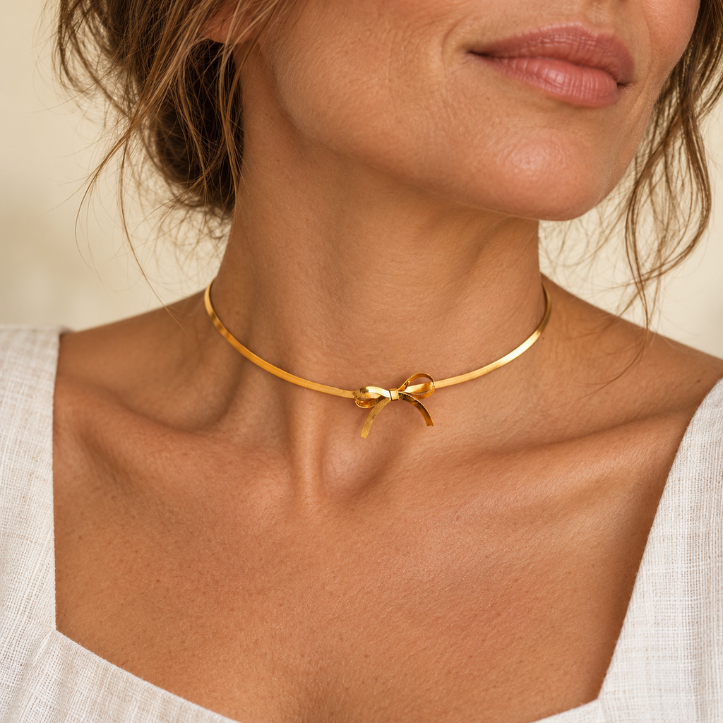 Gold bow choker on a woman