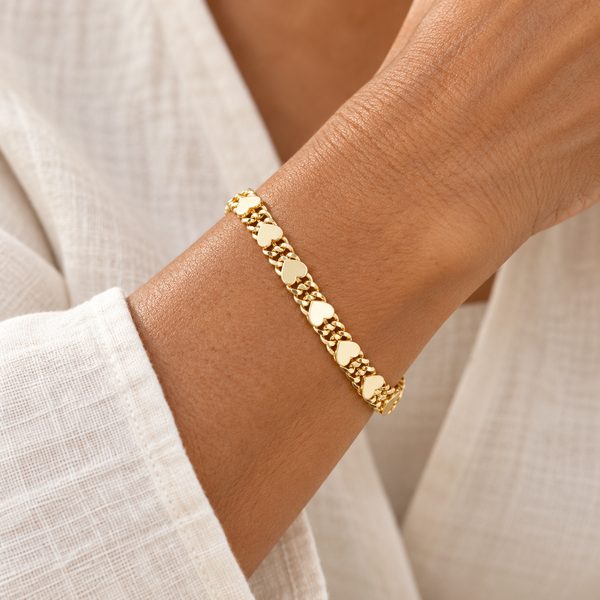 Gold double row heart link bracelet on a woman