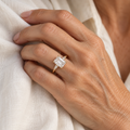 Gold emerald cut ring on a woman's hand