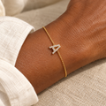 Gold A initial chain bracelet on a woman's wrist