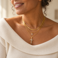 Three gold chains with initial and cross pendants